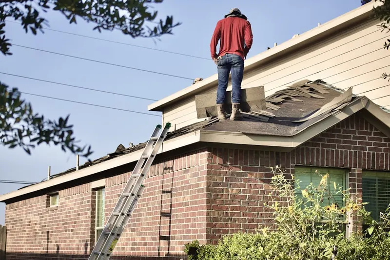 Professional roofer working on a residential roof in Columbia Lakes